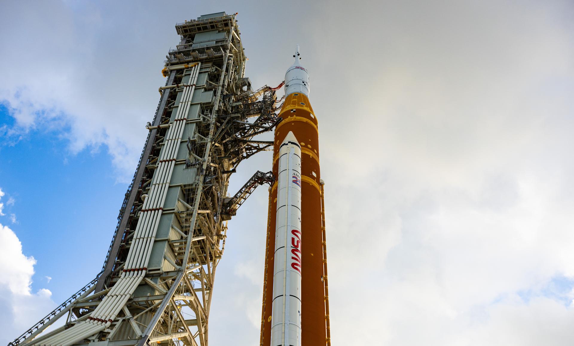 This image shows NASA’s SLS (Space Launch System) and Orion spacecraft rolling out of the Vehicle Assembly Building at NASA’s Kennedy Space Center. NASA's massive Crawler-Transporter, upgraded for the Artemis program, carries the powerful SLS rocket and Orion spacecraft on the Mobile Launcher from the Vehicle Assembly Building to Launch Pad 39B at Kennedy Space Center in preparation for the Artemis II mission.